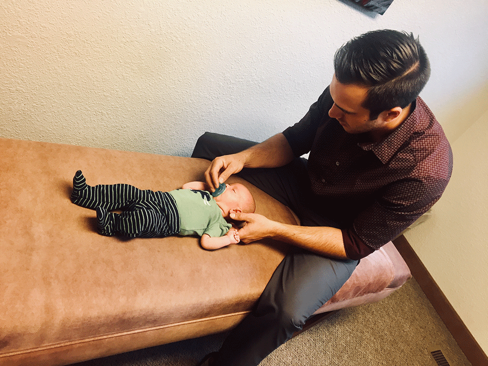 Baby receiving chiropractic care