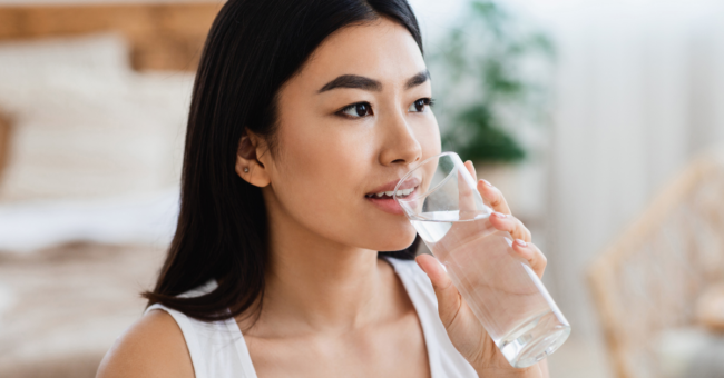 Person happily and healthily drinking water