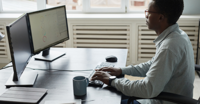 Person sitting at desk with bad posture