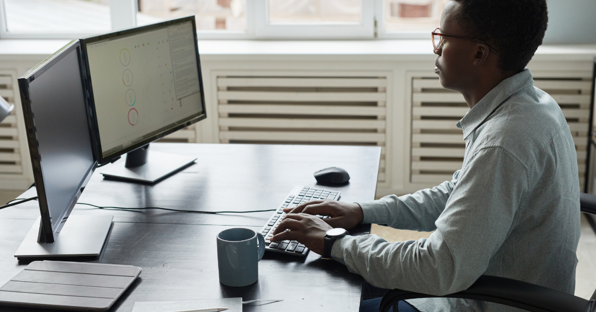 Person sitting at desk with bad posture